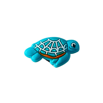 A PVC shoe charm shaped like a blue turtle.