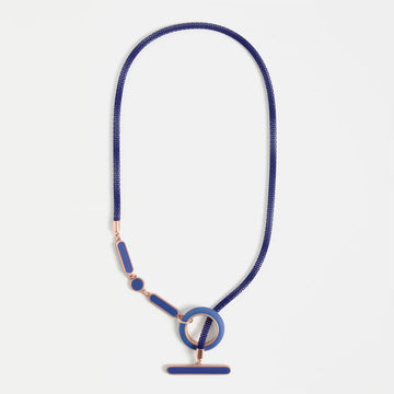 Blue necklace with a circular clasp on a light gray background.