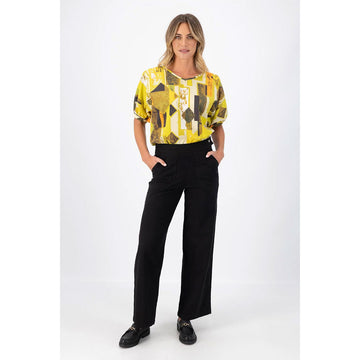 A pair of black pants with a button closure on the right side.