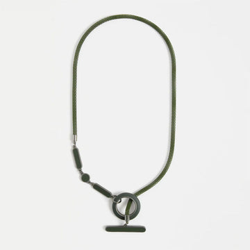 Green necklace with a round pendant on a white background.