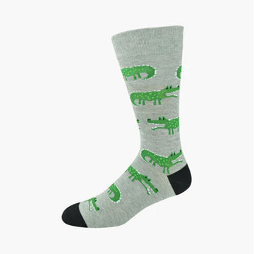 A grey sock with a black heel and toe and illustrated with crocodiles.