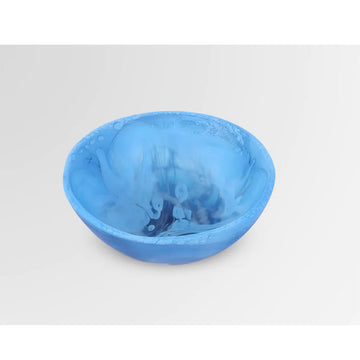 A bowl made from resin with blue swirls.