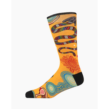 A yellow orange sock with a black heel and toe illustrated with Aboriginal artwork of a snake, kangaroo and round symbols.