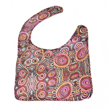 Colorful patterned baby bib on a white background.