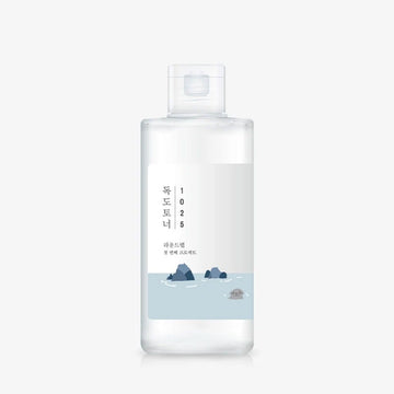 Clear bottle with a label featuring text and a small illustration on a white background
