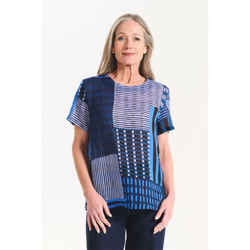 A women's top printed with a blue patchwork print.
