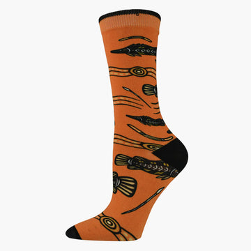 An orange sock illustrated with Aboriginal artwork of barramundi fish.