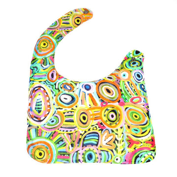 A baby bib printed with colourful artwork by Cedric Varcoe.