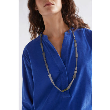 A gunmetal grey necklace with long triangular shapes and round beads on the necklace.