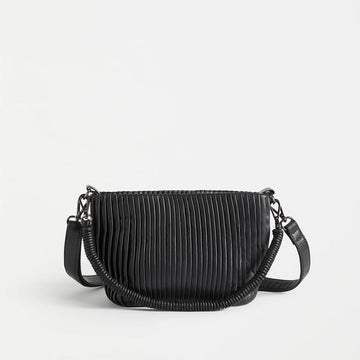 A very dark blue bag with a pleated design on the front and two straps.