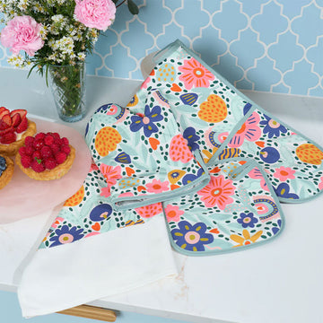 A white cotton tea towel with a strip of blue, pink and yellow flowers on the bottom half.