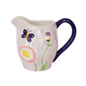 A ceramic jug in mauve with an embossed butterfly and flower with a dark purple handle.