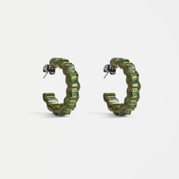 Pair of green hoop earrings with a zig zag shape on a white background.