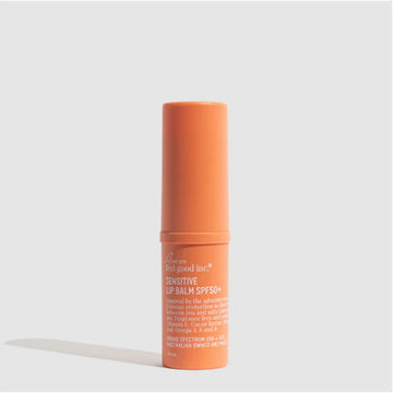 An orange tube of lip balm with white text around the outside.
