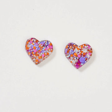 A pair of heart shaped stud earrings with orange and purple glitter.