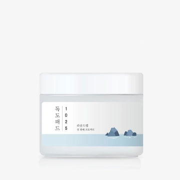Cosmetic container with a label featuring text and a minimal design on a white background