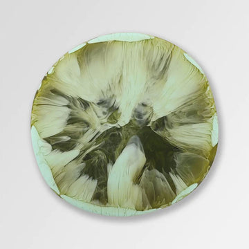 Top down view of a resin coaster with dark green swirls.