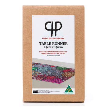 A brown box with the heading 'Table Runner' and an image of the runner inside with artwork Coral Hayes.