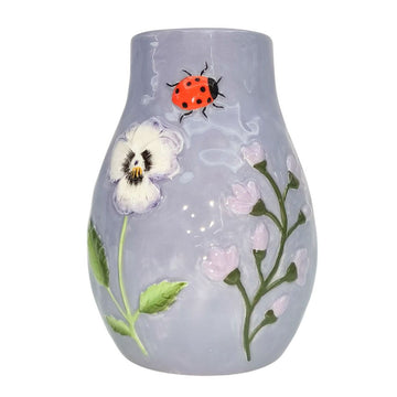 A mauve ceramic vase with an embossed ladybug and flowers.