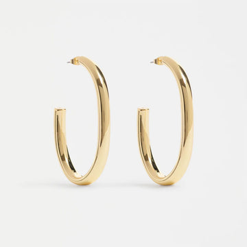 Gold hoop earrings on a light gray background.