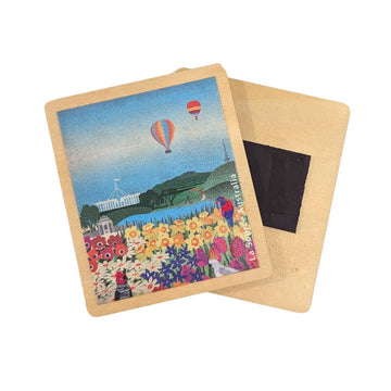 A wooden magnet illustrated with Canberra icons including hot air balloons, Parliament House and flowers.