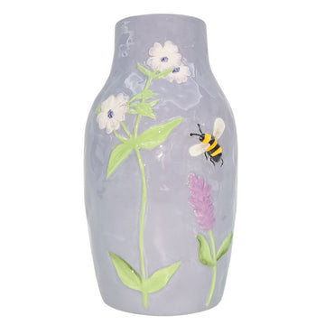 A ceramic mauve vase embossed with flowers and a bee.