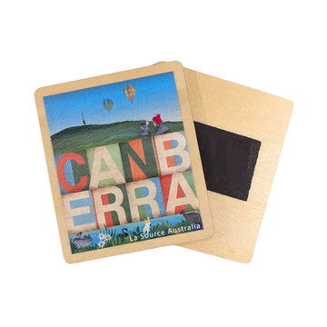 A wooden magnet illustrated with the word 'Canberra' with birds, hot air balloons and Telstra Tower.