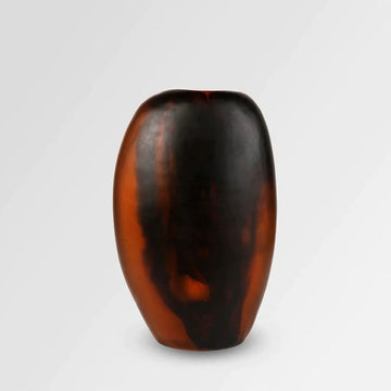 Front view of a tall rounded vase with brown swirls in resin.