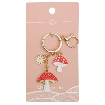 A gold keyring with two mushroom toadstool charms.