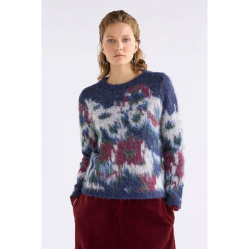 Multicolored sweater with abstract pattern on a white background.