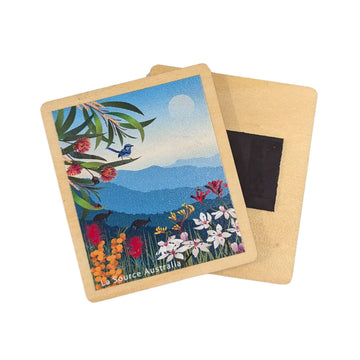 A wooden magnet illustrated with a landscape with flowers, kangaroos and a blue fairy wren.