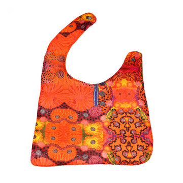 Colorful baby bib with intricate patterns on a white background.