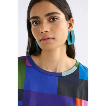 Two large dark blue geometric earrings on a light gray background.