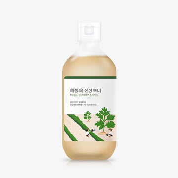Skincare bottle with green label and parsley illustration on a white background.