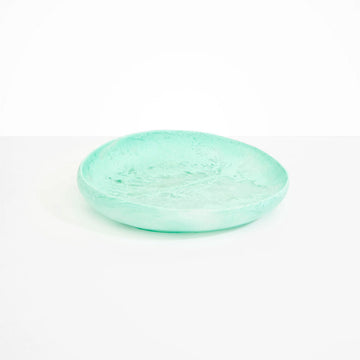 Top down and side view of a shallow resin bowl in mint green.
