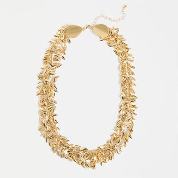 Gold leaf necklace on a white background.