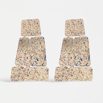 Pair of colorful terrazzo-patterned drop earrings on a white background.