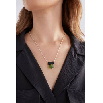 A necklace with a black rectangle and frosted clear ball pendant.