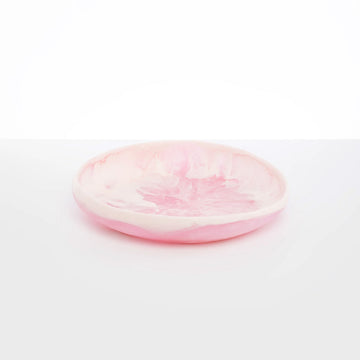 Top down and side view of light pink shallow resin bowl.