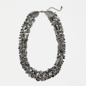 Gunmetal leaf-like necklace on a white background.