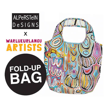 Colorful fold-up bag with abstract design, branded as ALPeRSTeIN DESIGNS x WARLUKURLANGU ARTISTS on a white background.
