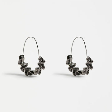 Pair of gunmetal hoop earrings on a light gray background.