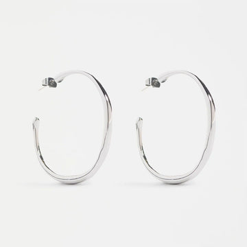 Silver hoop earrings on a white background.