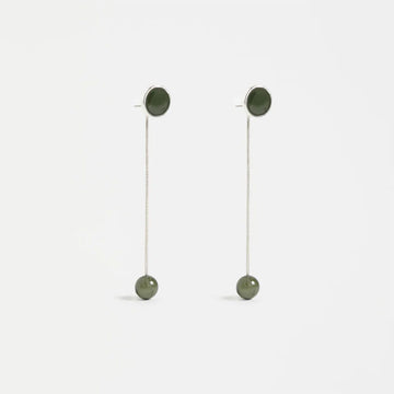 Pair of earrings with green spherical elements on a white background.
