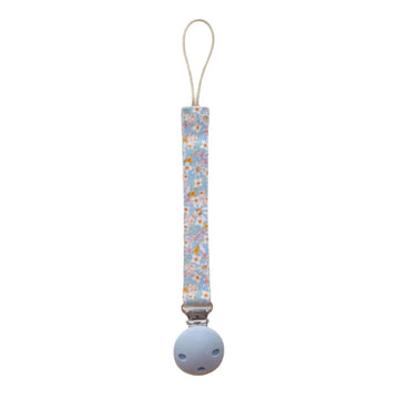 A dummy clip on a blue strap printed with gumnut babies by May Gibbs.