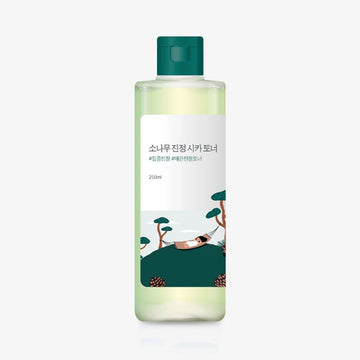 Bottle of skincare product with a green cap and label on a white background.