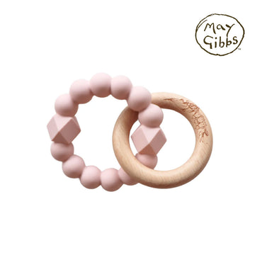 A silicone teething ring in blush pink linked to a wooden ring.