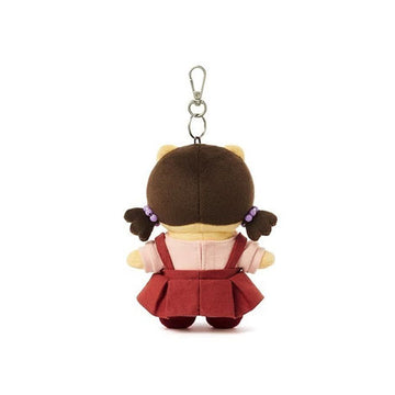Plush keychain of a cartoon character with a brown hat and red dress on a white background.