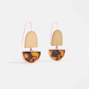 Gold earrings with tortoiseshell half-circle design on a white background.