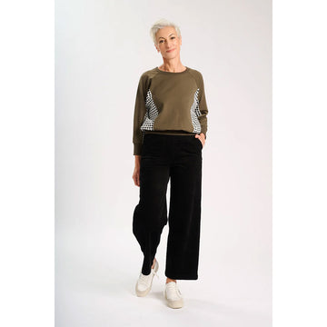 Black velvet pants on a white background.